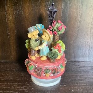 Bear musical figurine on a rotating pedestal.